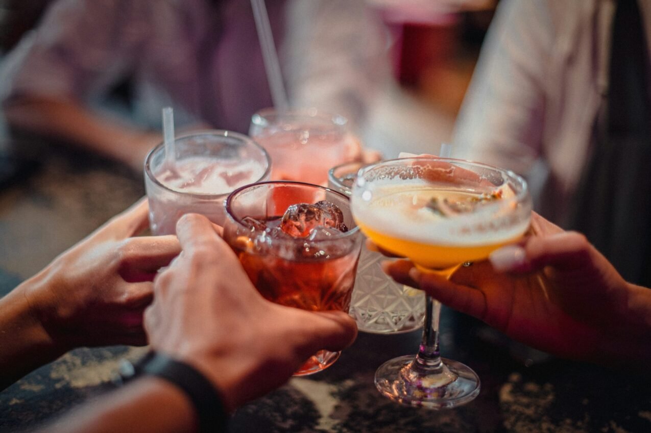 Group of people holding glasses of cocktails 