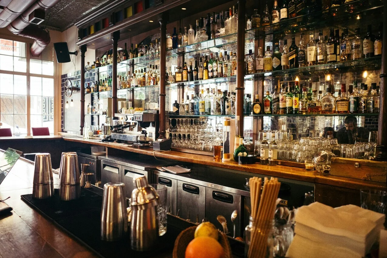 Bar with lots of alcohol bottles in the background